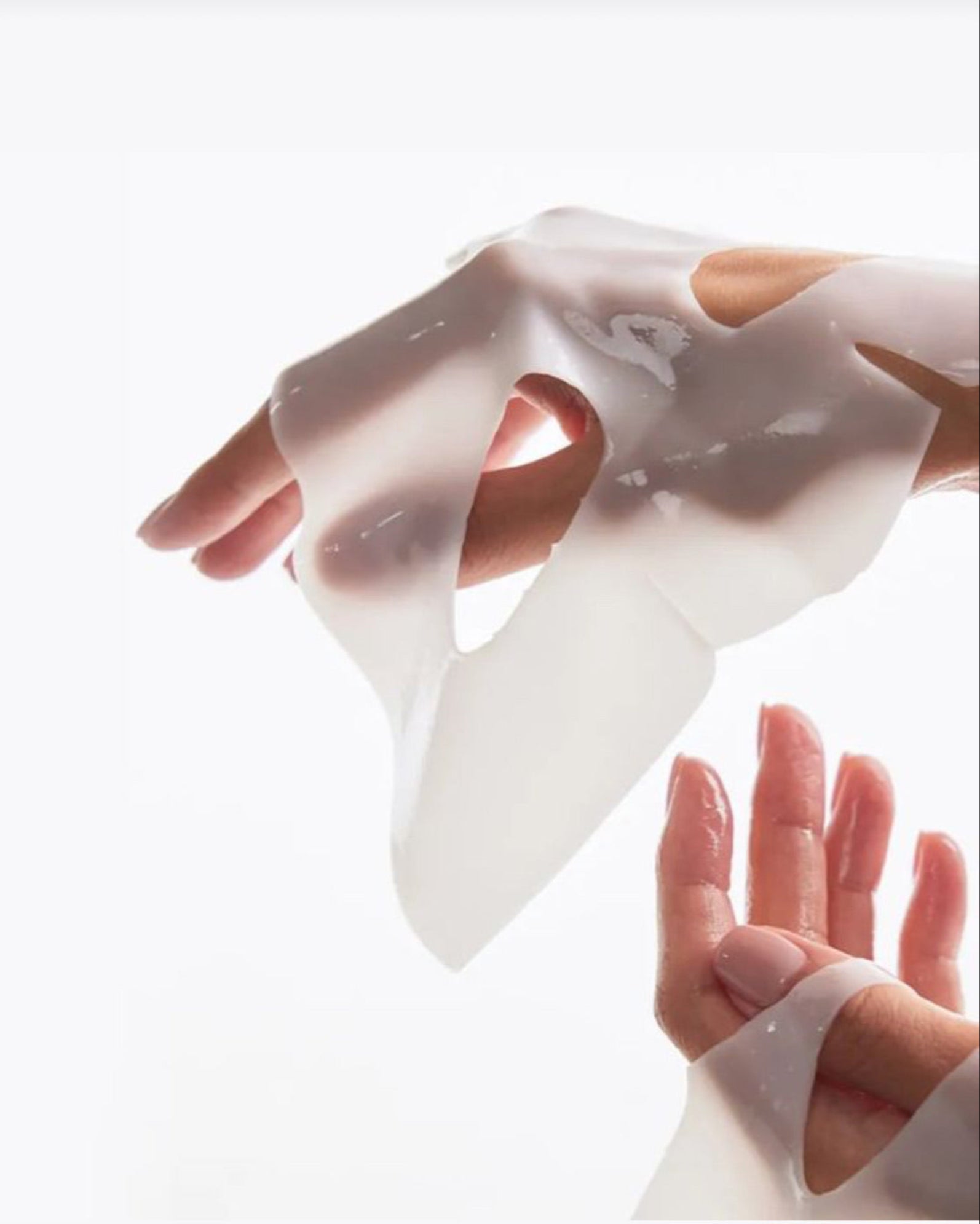collagen mask displayed on hands on a white background